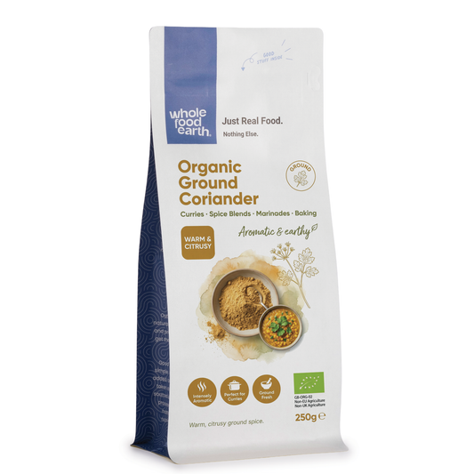 Organic ground coriander in a clear glass jar from ArtisanBox, showing the finely ground spice inside.