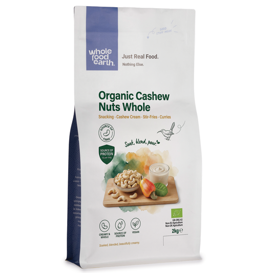 Whole Food Earth organic whole cashew nuts in a bowl, showcasing their creamy, curved shape and natural light beige color.