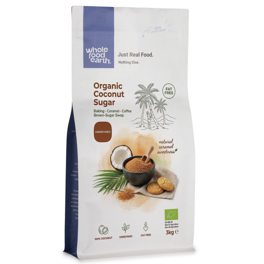 Organic coconut sugar in a clear glass jar from Whole Food Earth, showing the light brown, granulated sugar inside.