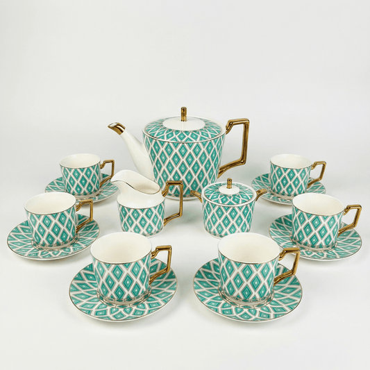 Elegant Edwardian tea set by KitchBoom featuring emerald accents and delicate bone china cups and saucers.