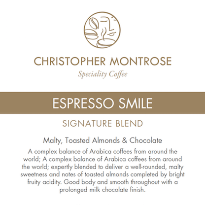 Christopher Montrose Coffee Arabica Espresso Smile coffee beans in a labeled bag, showcasing the colorful design and branding.