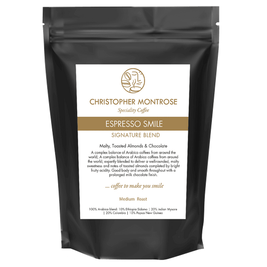 Close-up of Christopher Montrose Coffee Arabica Espresso Smile coffee beans on a transparent background.