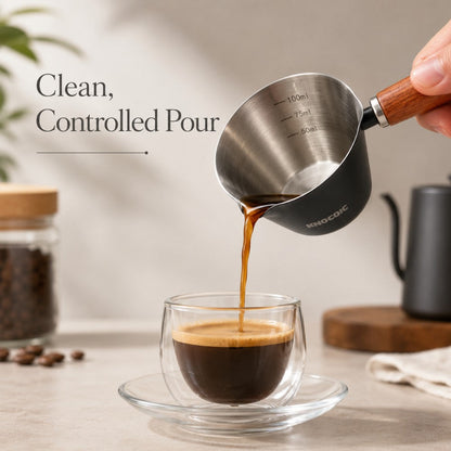 KNOCDIC® 100ml espresso measuring cup pouring liquid, made of clear glass with measurement markings for accurate coffee brewing.