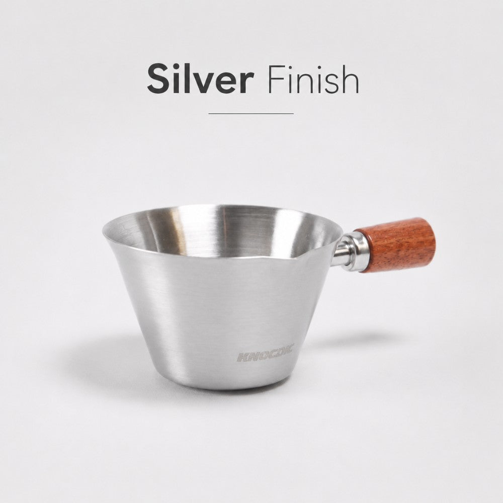 Silver KNOCDIC® espresso measuring cup with 100ml capacity, featuring clear measurement markings and a sleek design.
