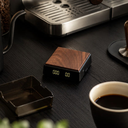 KNOCDIC® Mini coffee scale with timer for precise espresso measurement, featuring a sleek black design on a coffee setup.
