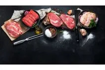 Assorted Primrose Herd Essentials Meat Box with various cuts of fresh meat in a cardboard box.