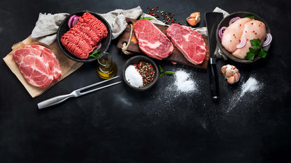 Primrose Herd Family Meat Box with assorted raw meats, including steaks, sausages, and cuts, displayed in a clean, organized arrangement.