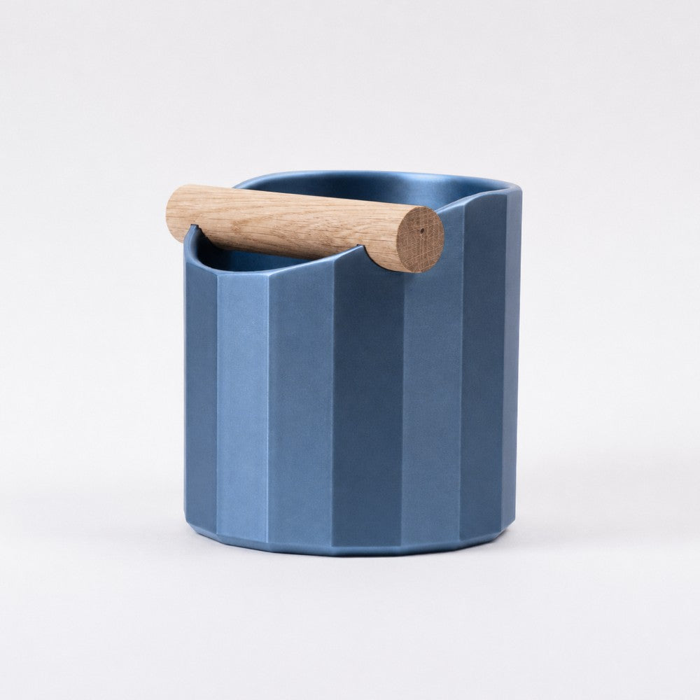 KNOCDIC® Facet Geometric Espresso Knock Box in metallic blue with oak knock bar for coffee taming and countertop convenience.