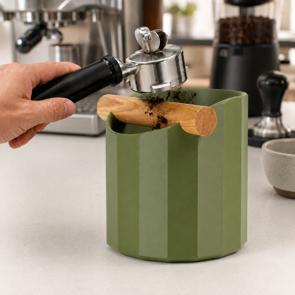 KNOCDIC Facet Geometric Espresso Knock Box with oak knock bar for coffee grounds disposal, in use on a countertop.