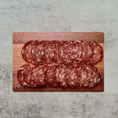 Sliced fennel salami from Bray Cured on a charcuterie board, showing thin slices of artisanal cured salami with fennel seeds.