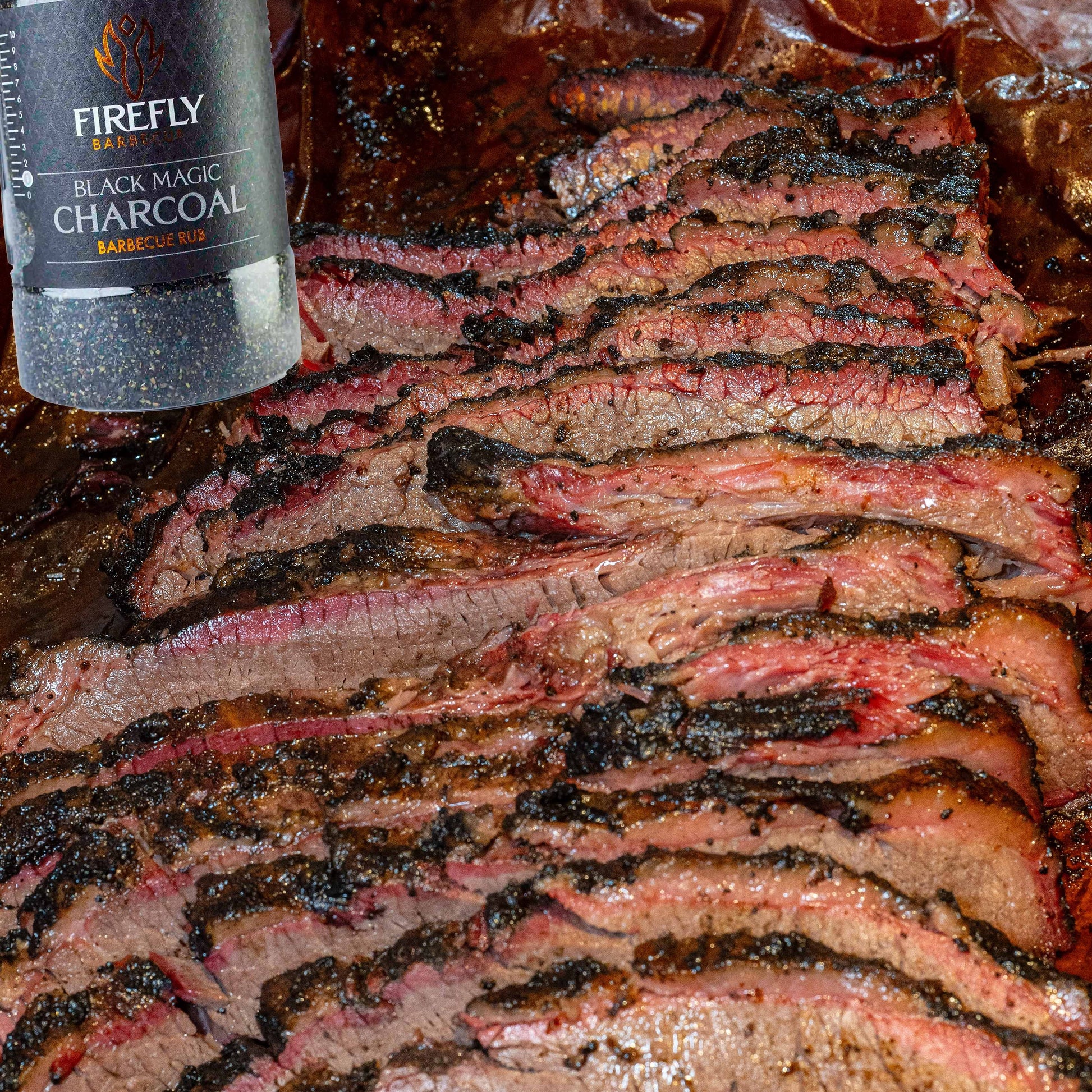 FireFly Barbecue Black Magic Charcoal Beef Rub in a jar, ideal for enhancing grilled beef with smoky seasoning.