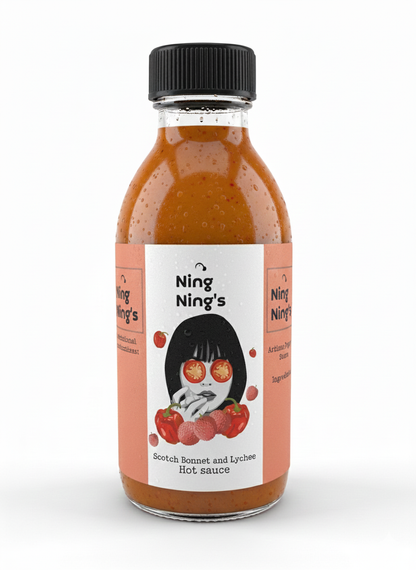 Ning Nings Scotch Bonnet & Lychee Pepper Sauce bottle with vibrant red chili sauce visible inside, featuring a label with colorful design.