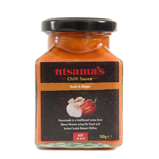 Bottle of Ntsama.co.uk ginger and garlic sauce with fresh ginger and garlic visible on the label.