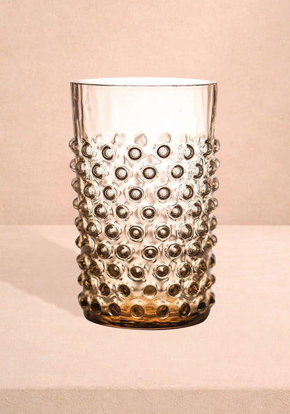 Set of four bronze dew drop glass tumblers by Casa, featuring a unique textured design perfect for stylish beverage presentation.