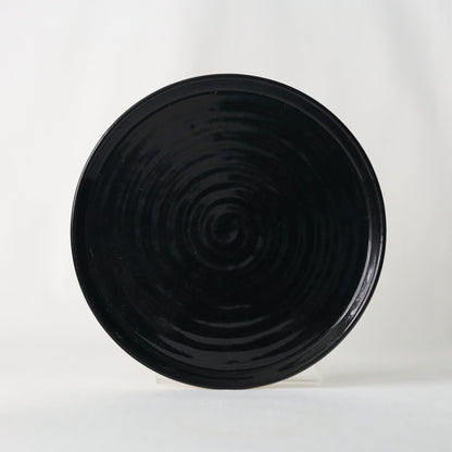 Handmade jet black ceramic side plate by Katie L Thompson Designs, showcasing elegant, minimalist design and smooth finish.