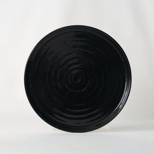 Handmade jet black ceramic side plate by Katie L Thompson Designs, showcasing elegant, minimalist design and smooth finish.
