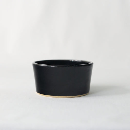 Handmade black ceramic side bowl by Katie L Thompson Designs, elegant and versatile for serving or decor.