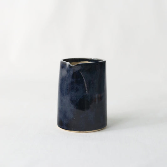 Handmade black ceramic small jug by Katie L Thompson Designs, featuring a sleek jet black finish and classic design.
