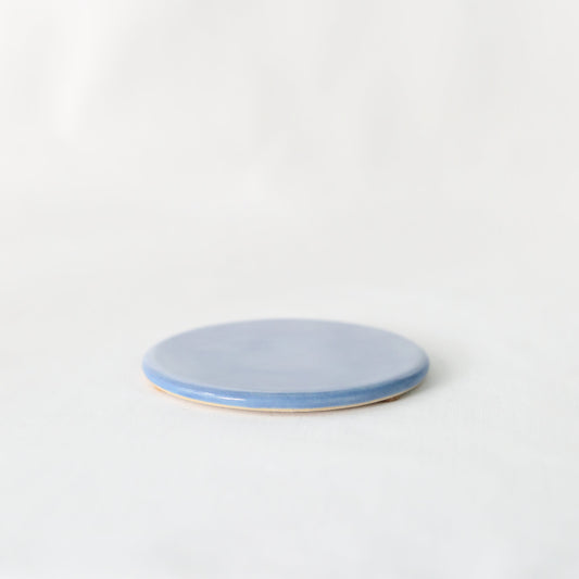 Handmade Pacific Blue ceramic coaster by Katie L Thompson Designs featuring a classic, artisanal design on a smooth surface.