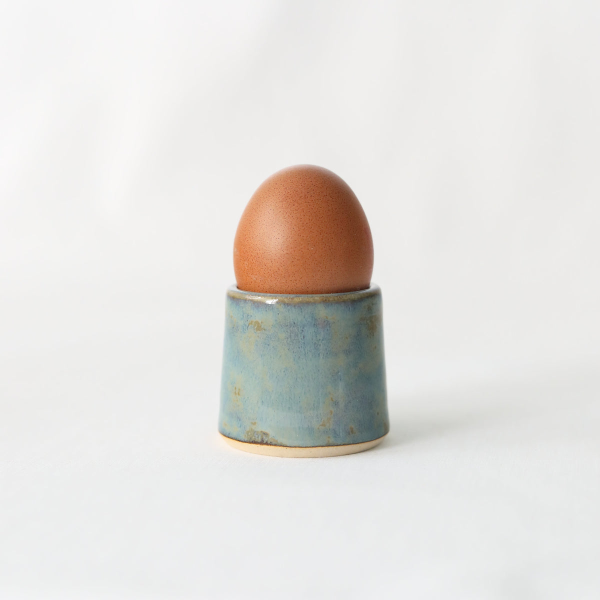 Handmade seafoam blue ceramic egg cup by Katie L Thompson Designs, featuring a classic, smooth, rounded shape for breakfast.