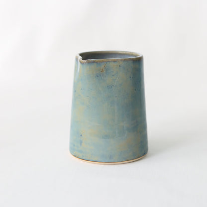 Seafoam blue ceramic small jug by Katie L Thompson Designs, handcrafted with a smooth, rounded shape and glossy finish.