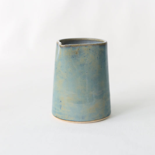 Seafoam blue ceramic small jug by Katie L Thompson Designs, handcrafted with a smooth, rounded shape and glossy finish.