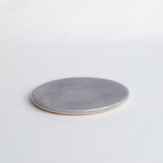 Handmade ceramic amethyst purple coaster by Katie L Thompson Designs, with a smooth, glossy finish and intricate design.