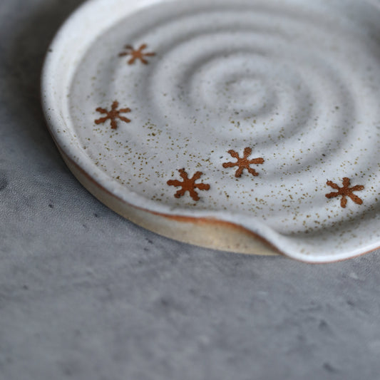 Handmade ceramic pepper white rustic snowflake spoon rest by Katie L Thompson Designs, featuring a cozy winter-inspired design.