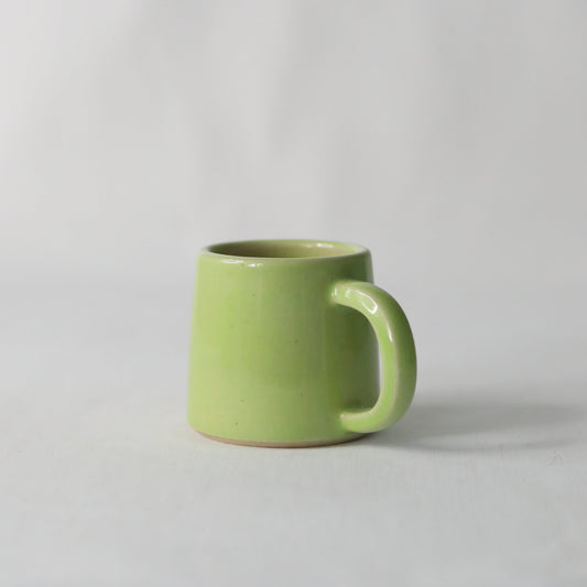 Handmade spring green ceramic espresso mug by Katie L Thompson Designs, featuring a classic, ergonomic shape and smooth finish.