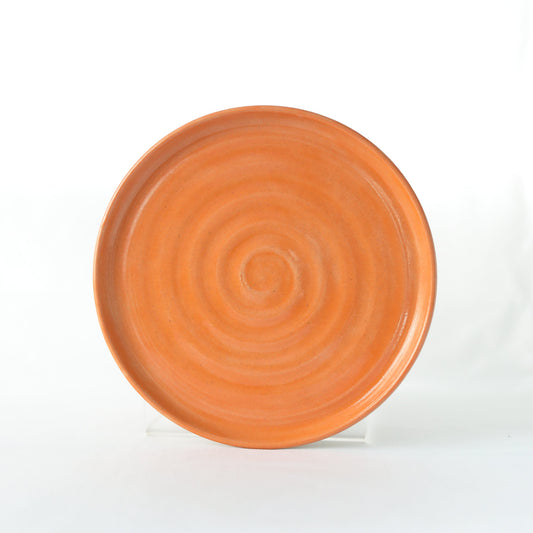 Handmade ceramic cake plate with a vibrant mandarin orange design by Katie L Thompson Designs.
