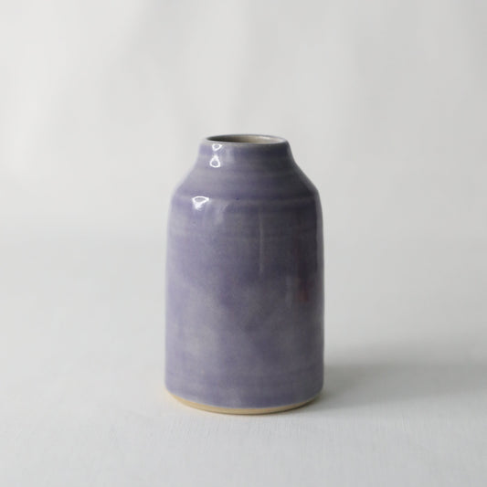 Handmade purple ceramic reed diffuser with natural reeds, designed by Katie L Thompson Designs for a stylish home fragrance.