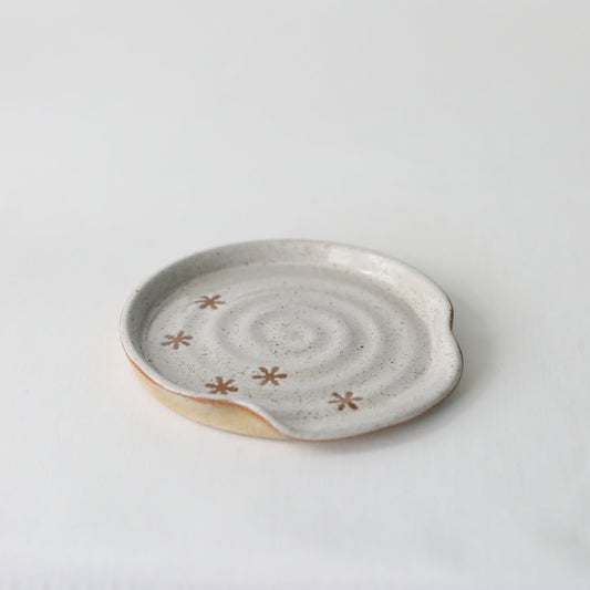Handmade white ceramic pepper white rustic snowflake spoon rest by Katie L Thompson Designs, with detailed snowflake design.