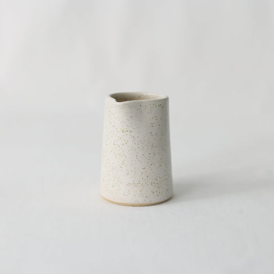 White ceramic mini jug by Katie L Thompson Designs, featuring a classic and handmade design perfect for small servings or decor.