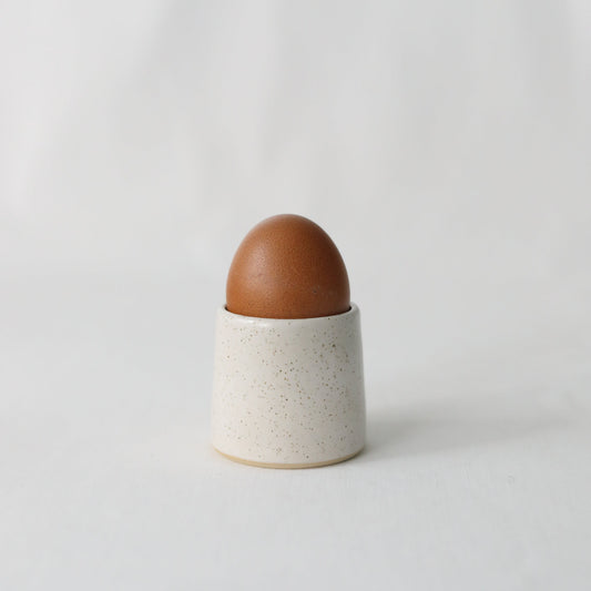 Handmade white ceramic egg cup from Katie L Thompson Designs, classic style for serving soft-boiled eggs.