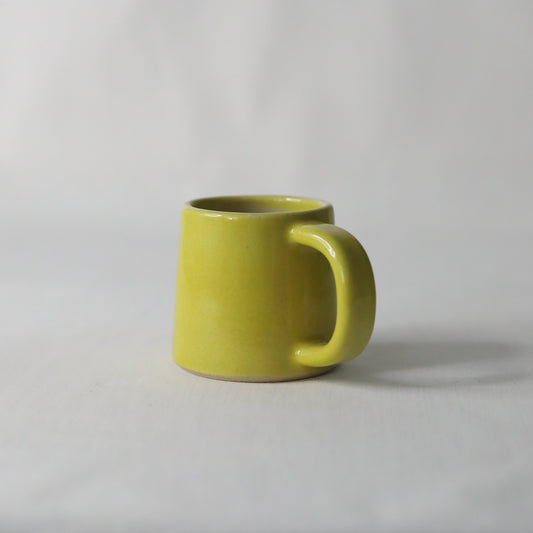 Sun yellow ceramic espresso mug by Katie L Thompson Designs, handmade with a classic shape and vibrant yellow glaze.