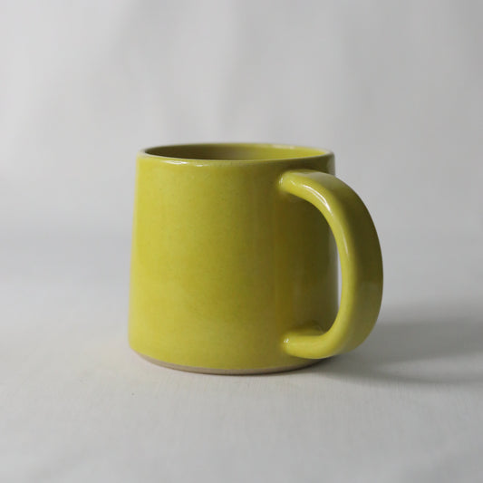 Handmade Sun Yellow Classic Standard Mug by Katie L Thompson Designs, ceramic mug with a bright yellow finish and smooth handle.