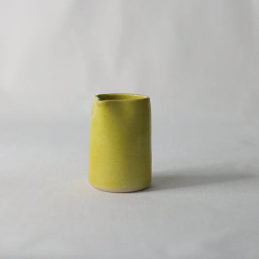 Handmade Sun Yellow Classic Mini Ceramic Jug by Katie L Thompson Designs, with a smooth, glossy finish and small handle.