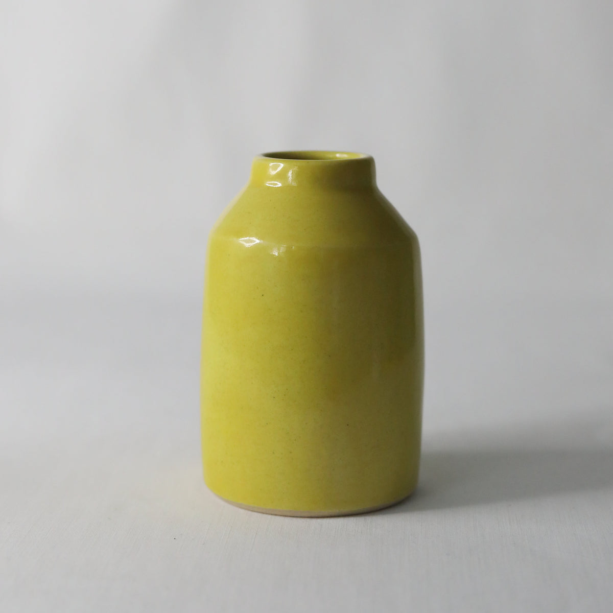 Handmade sun yellow ceramic Bud Vase by Katie L Thompson Designs, showcasing a classic, smooth ceramic finish and elegant shape.