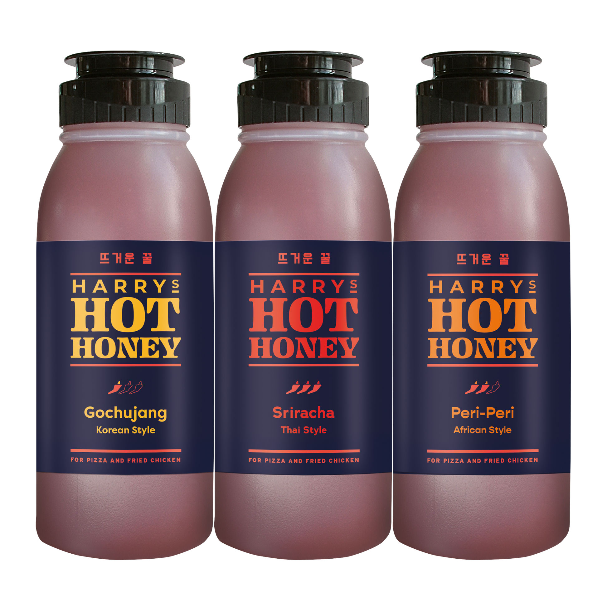 Three Harry's Hot Honey fusion sauces in gochujang, sriracha, and Thai flavors in glass bottles on a white background.
