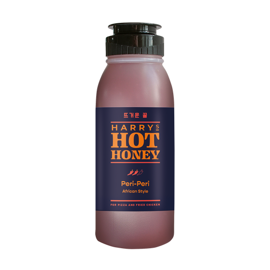 Harry's Hot Honey Peri-Peri bottle with spicy honey and Peri-Peri flavor, displayed in a clear glass bottle.
