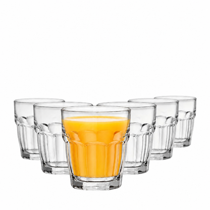 Set of six Bormioli Rocco Rocks Bar Juice Glasses with 215ml capacity, featuring clear whisky tumblers with juice in the front glass.