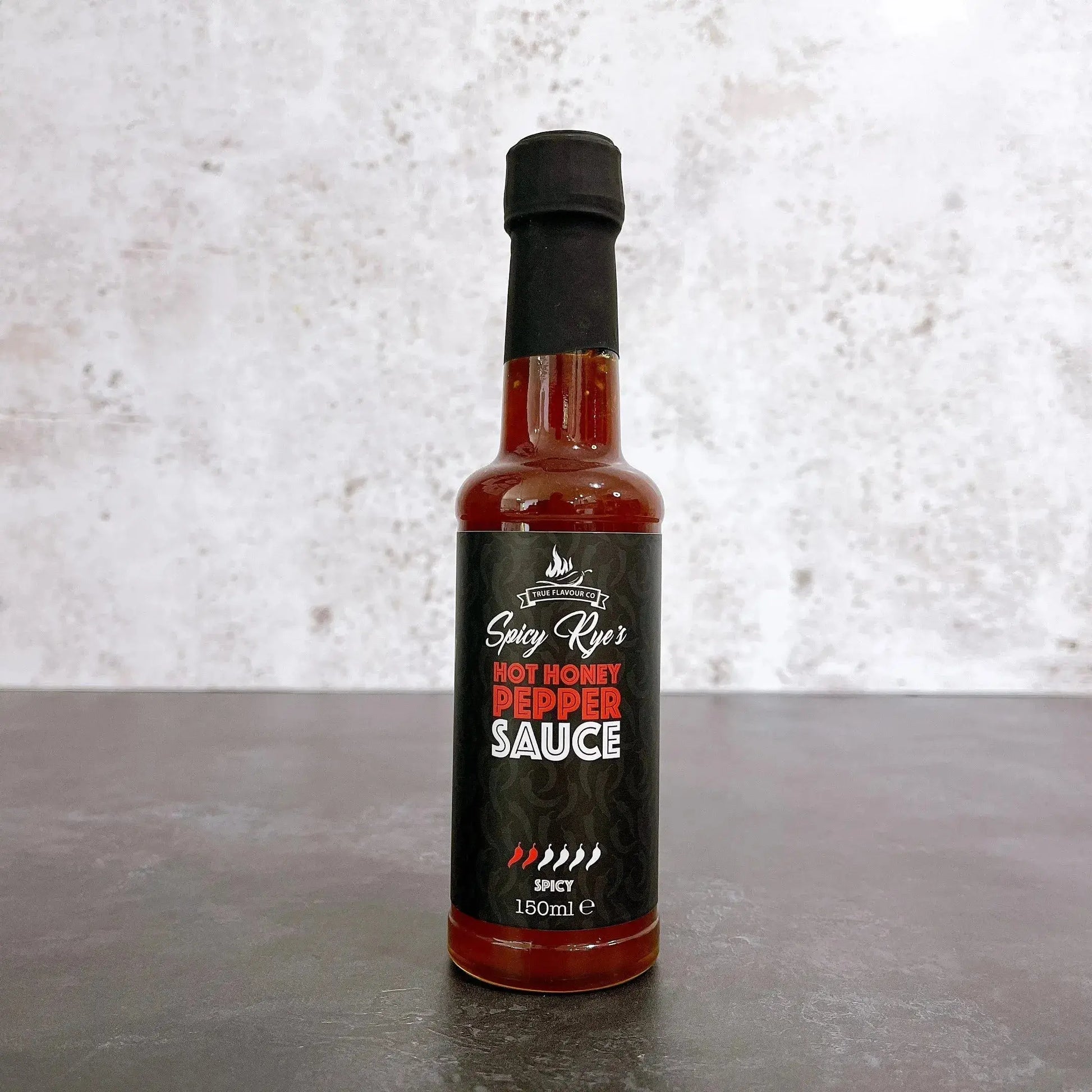 Spicy Ryes Hot Honey Pepper Sauce bottle with label, showcasing the hot sauce in a clear glass bottle with a colorful label.