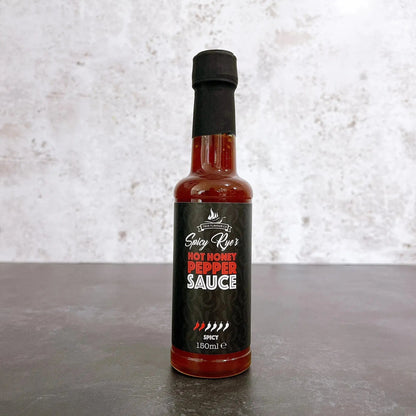 Spicy Ryes Hot Honey Pepper Sauce bottle with label, showcasing the hot sauce in a clear glass bottle with a colorful label.