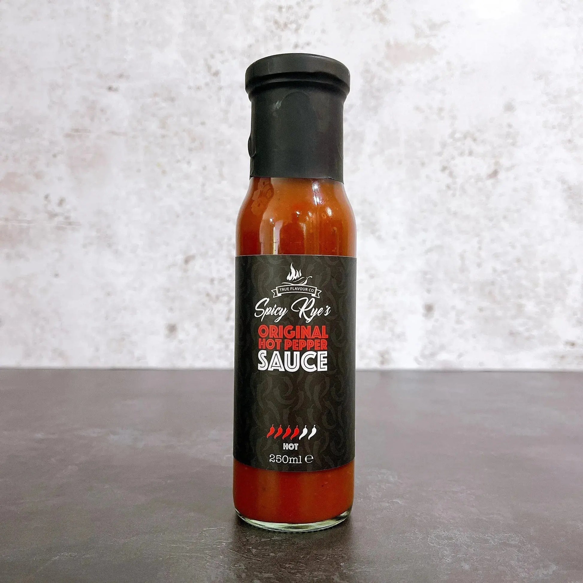 Spicy Ryes Original Hot Pepper Sauce bottle with bright red label and fiery hot sauce inside, ready to add heat to dishes.