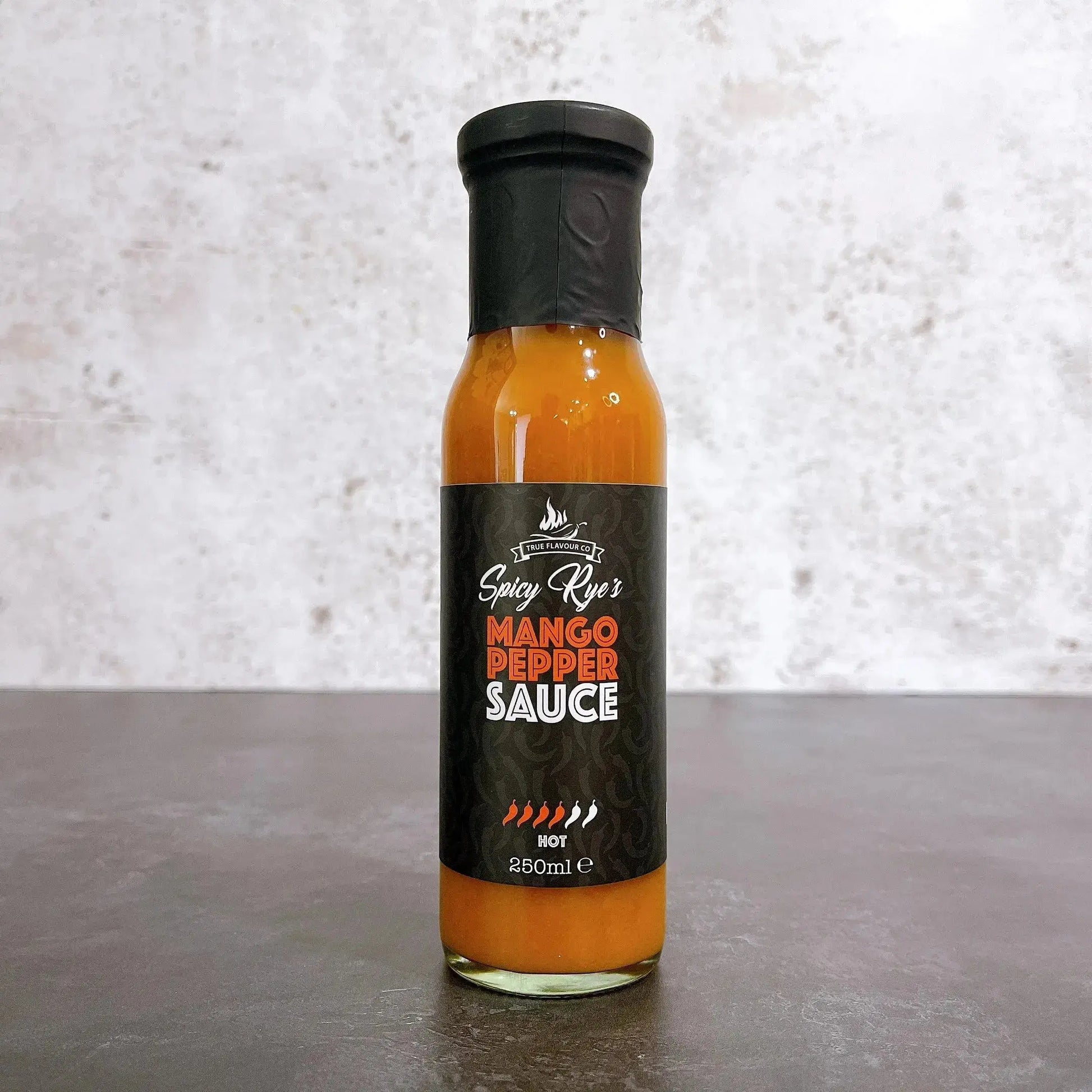 Spicy Ryes Mango Pepper Hot Sauce bottle with vibrant label, showcasing the flavorful mango and pepper ingredients.