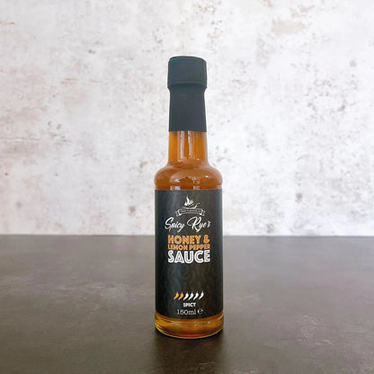 Spicy Ryes honey and lemon pepper hot sauce in a glass bottle with a label, showcasing the flavorful sauce inside.