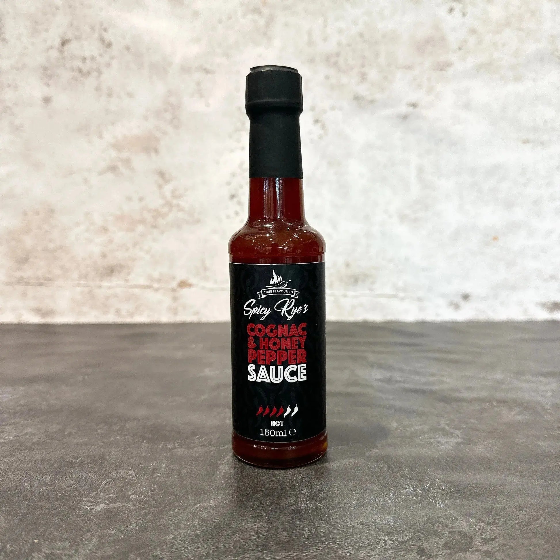Spicy Ryes Cognac & Honey Pepper Sauce bottle, marinades and grilling sauce with rich amber color and pepper chunks visible.