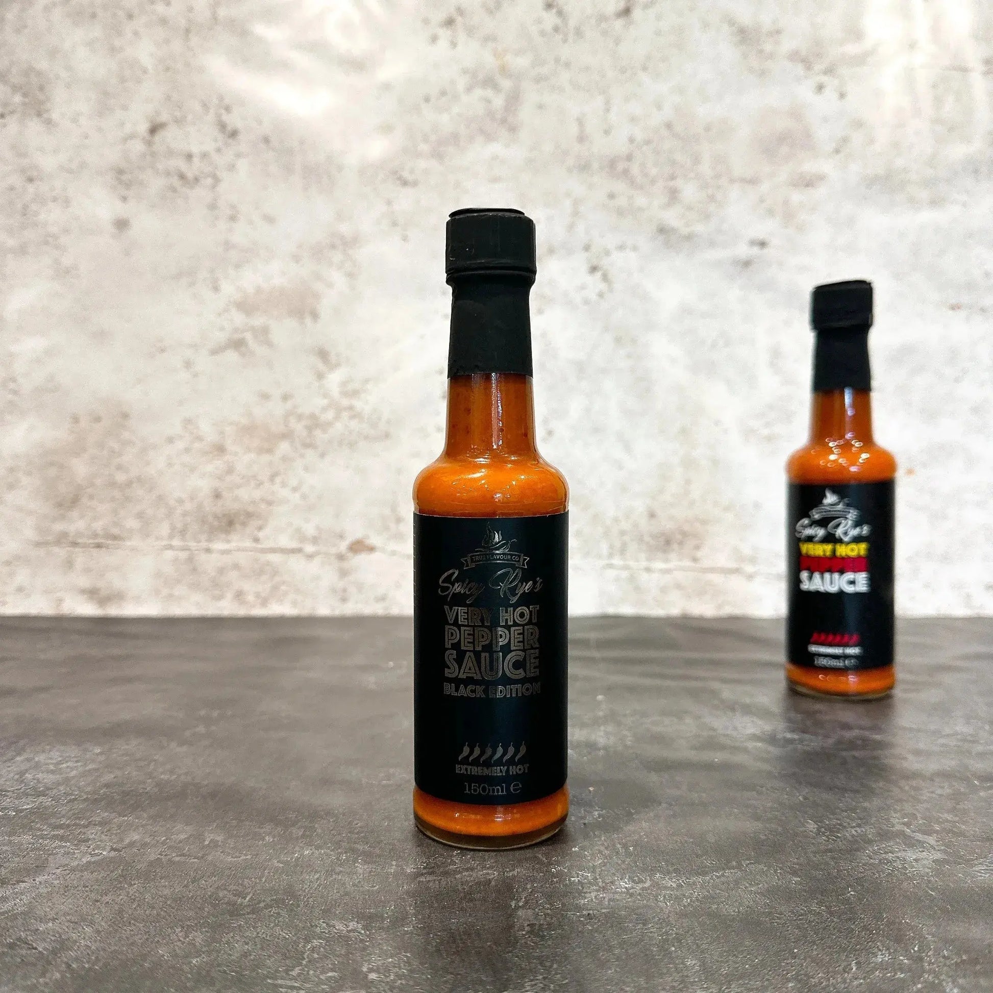 Spicy Ryes Very Hot Pepper Sauce Black Edition bottle with dark label and red pepper illustration, showcasing the hot sauce.