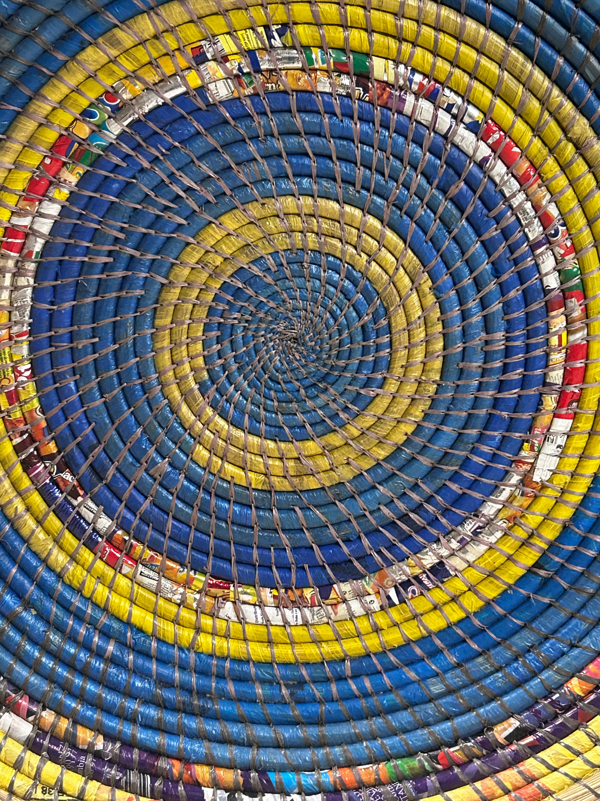 Zambian Wall Basket by Botanical Boys, woven basket with natural fibers, hanging on a wall for decorative storage or display.