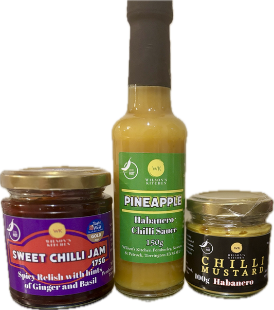 Assorted Wilson’s Kitchen Habanero artisan chili sauces in bottles, showcasing vibrant labels and spicy chili ingredients.